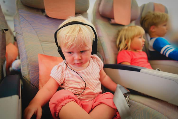 baby in airplane with headphones on