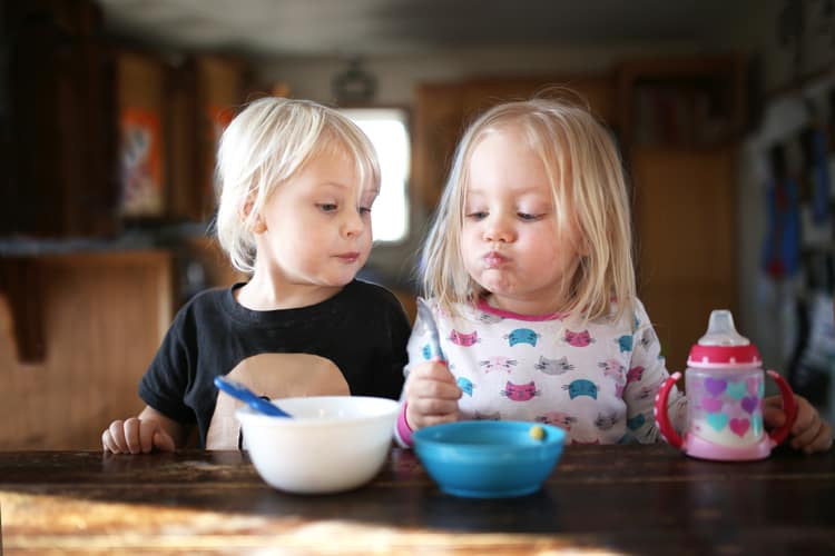 twins eating breakfast on a trip to visit grandma
