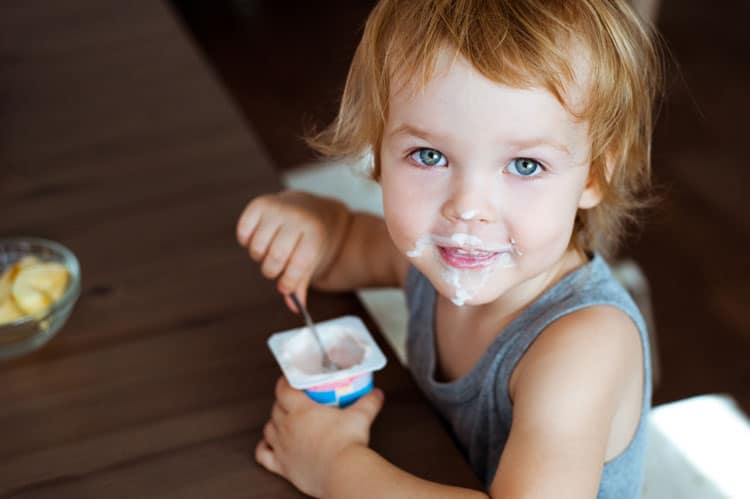 child eating yogurt
