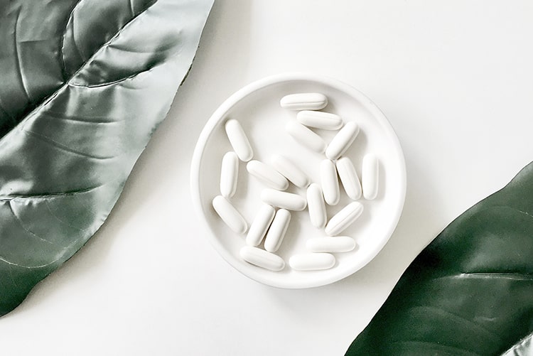 How to Increase & Maintain Breast Milk Supply: Tips from a Holistic Certified Nutritionist 8 vitamins and supplements in a dish