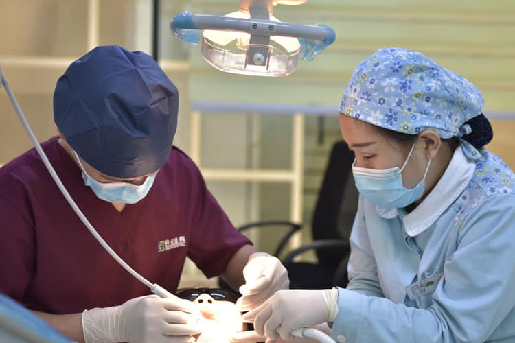 Top 6 Dental Myths that Every Pregnant or Breastfeeding Woman Should Know 3 dentist and assistant performing dental work