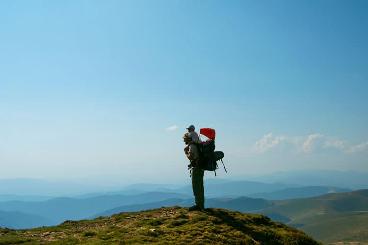 father hiking with child in mountains