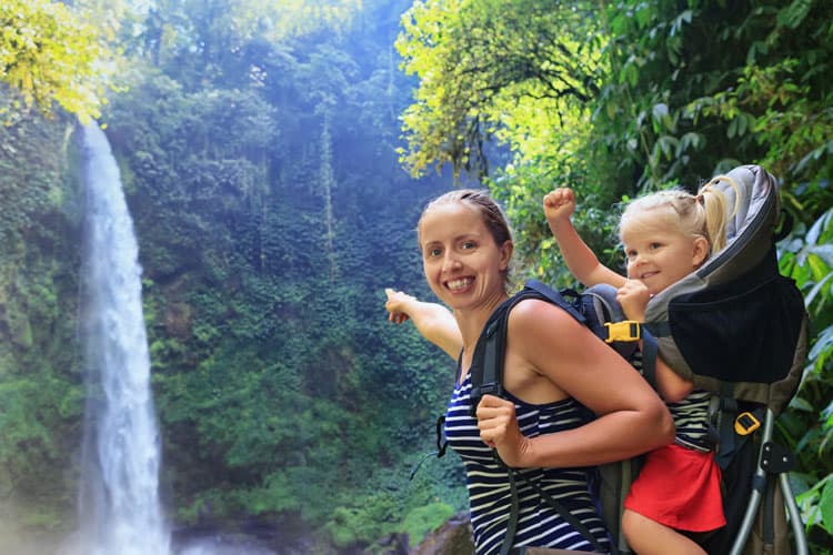 mother and daughter looking at a waterall