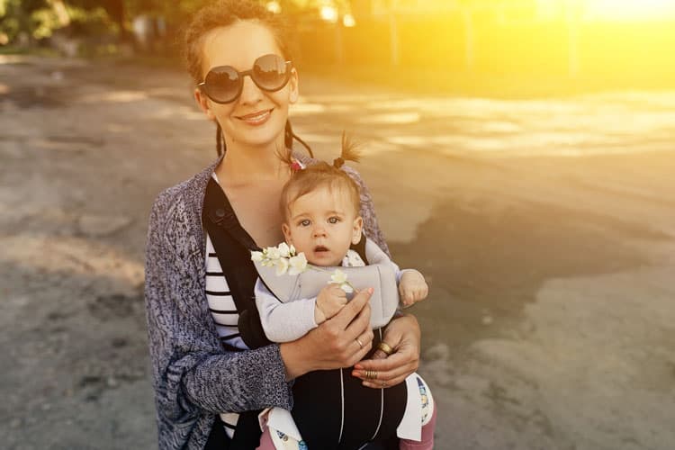 mom hiking with baby in baby carrier