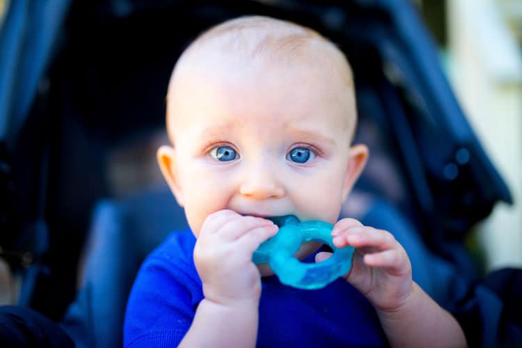{UPDATED} Is My Baby Teething? 5 baby chewing on teething ring