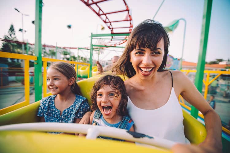 woman and kids on roller coaster
