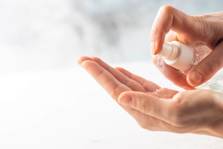 20 Coronavirus Travel Tips to Keep Your Family Safe 10 person using hand sanitizer during covid