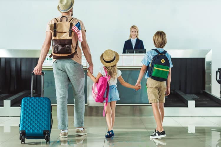 20 Coronavirus Travel Tips to Keep Your Family Safe 16 family checking in at hotel