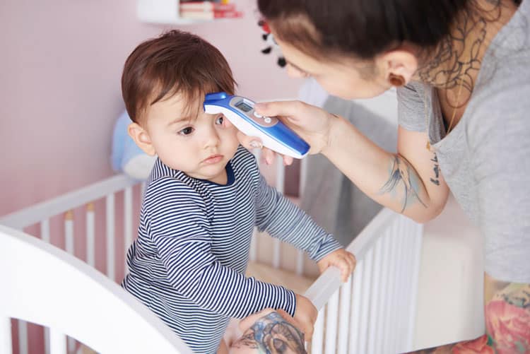 20 Coronavirus Travel Tips to Keep Your Family Safe 14 mother taking baby's temperature