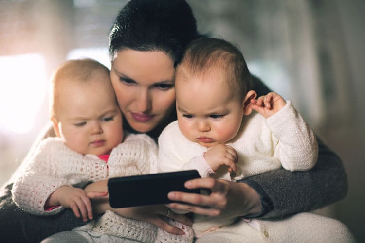 20 Coronavirus Travel Tips to Keep Your Family Safe 21 mother reading to her twins