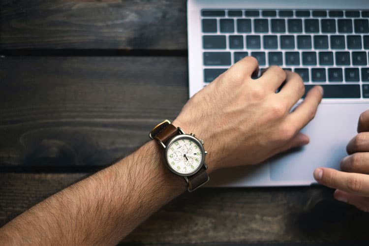 wrist watch on mans arm