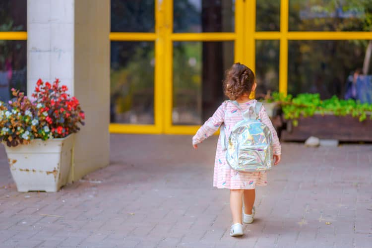 How to Help Your Child With Back-to-School Anxiety 4 small girl walking into school