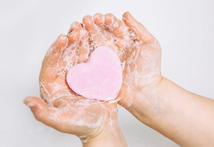 How to Keep a Clean Car with Kids: 7 Simple Tips 2 sudsy hands with a bar of soap