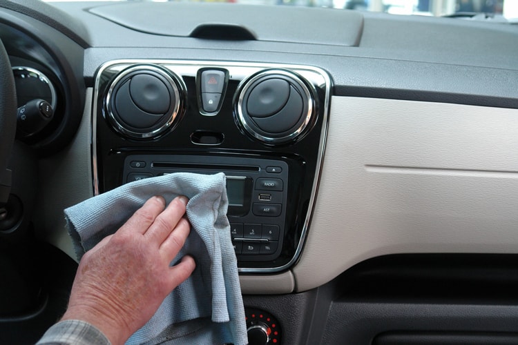 How to Keep a Clean Car with Kids: 7 Simple Tips 8 person cleaning the inside of a car