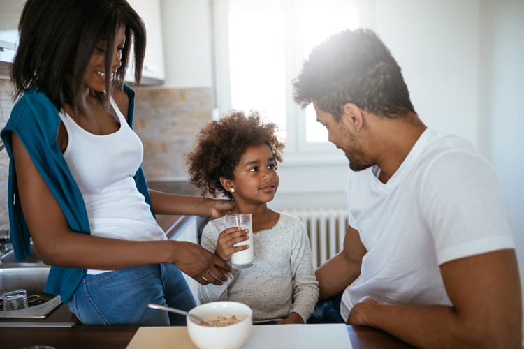 mother and father talking to their daughter