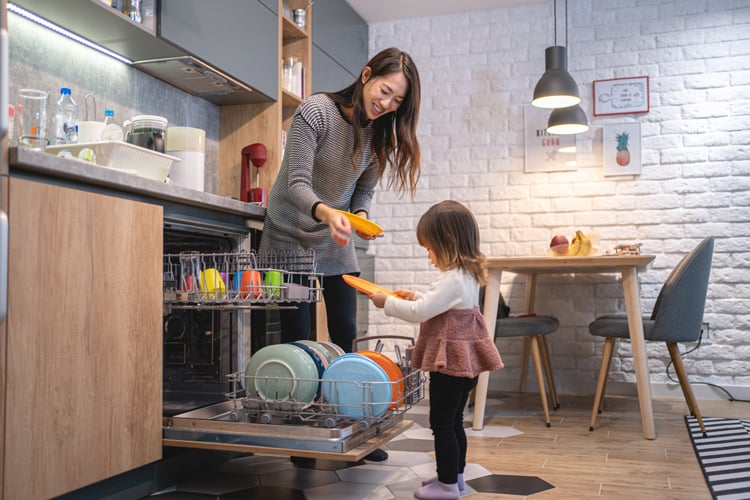 10 Tips for Keeping a Clean House With Kids 2 mom showing daughter how to load dishwasher