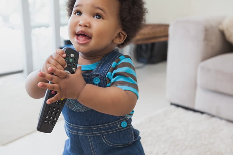 What To Clean When Your Child Is Sick 6 Child Holding A Remote Control