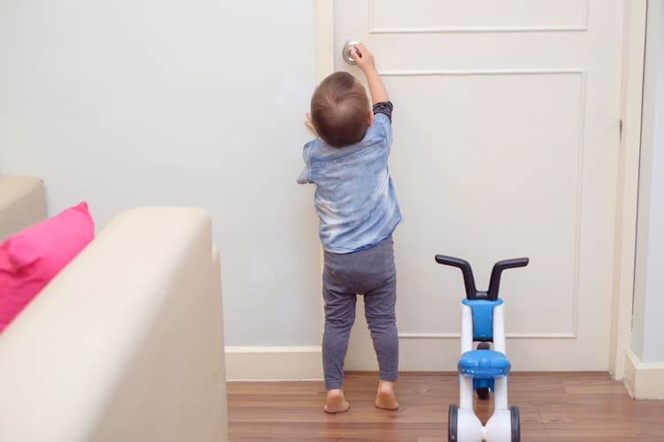What To Clean When Your Child Is Sick 10 Child Reaching For A Door Handle