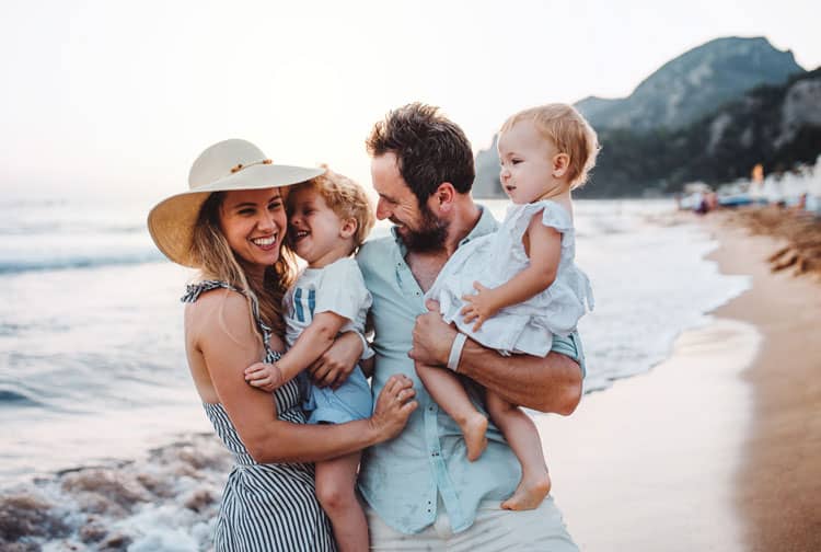 travel is back - happy family on the beach