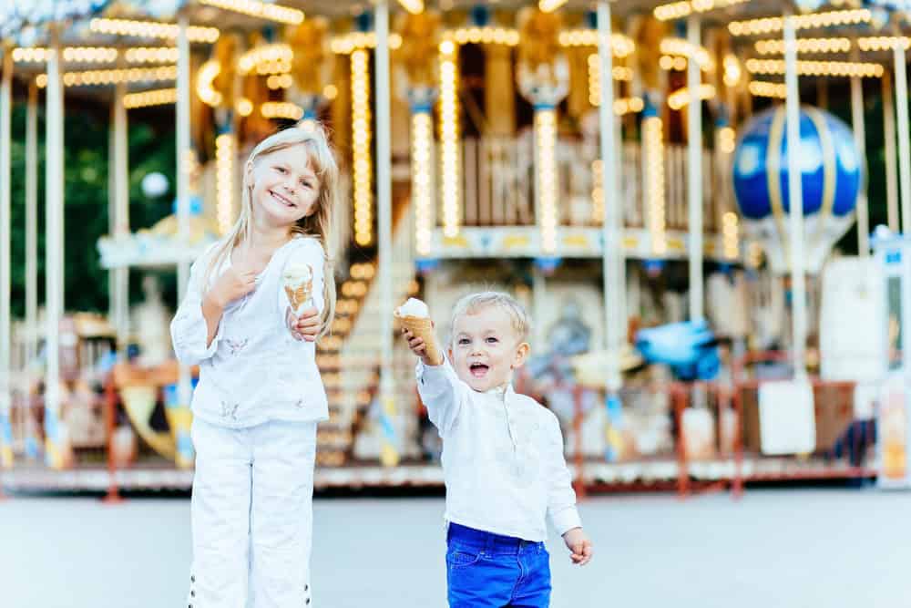 Child enjoying ice cream at Sesame Place amusement park.