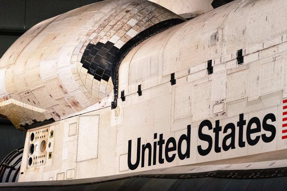 Space shuttle Atlantis displayed at Kennedy Space Center, Florida, with "United States" visible on t.