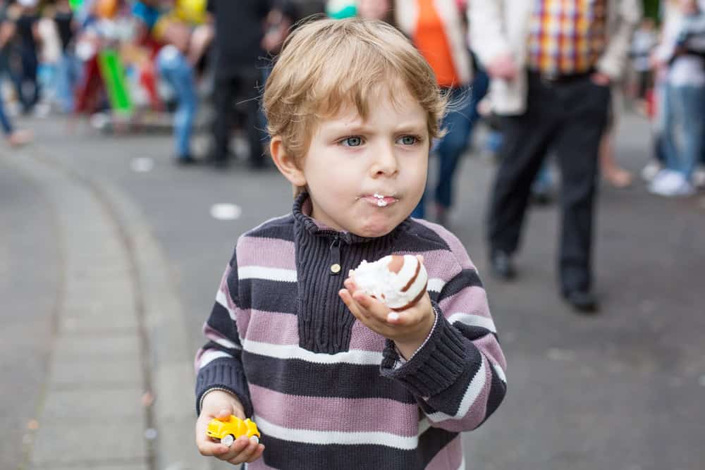 Child enjoying a cupcake at Sesame Place with food allergies.