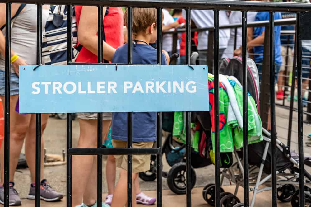 Stroller parking area at Sesame Place with families and strollers lined up.