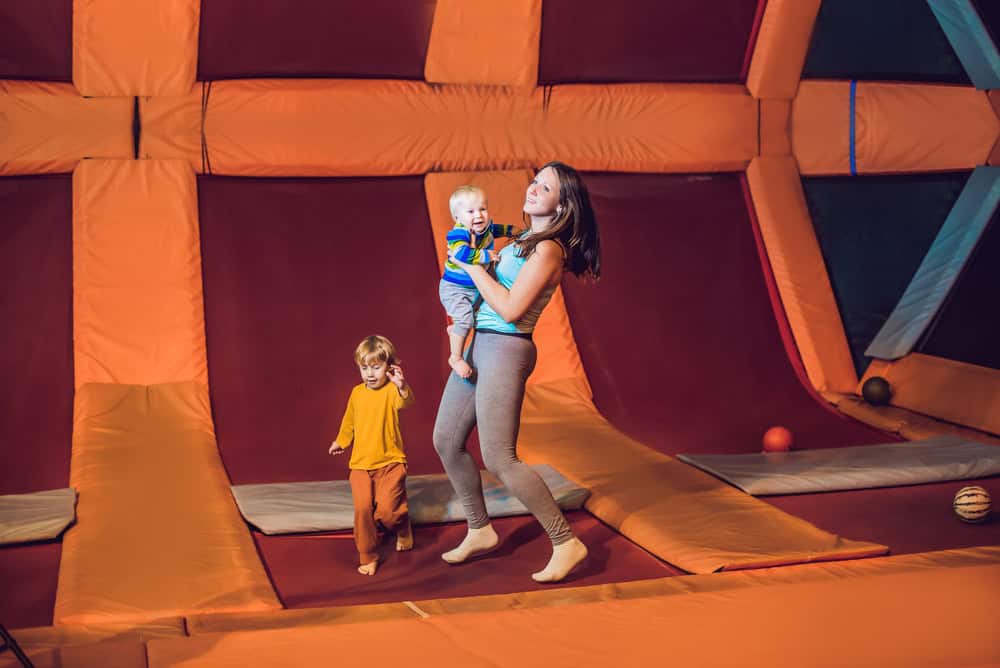 Mother And her son jumping on a trampoline in fitness park
