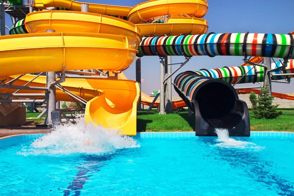 Colorful water slides at Wisconsin Dells waterpark with splash pool.