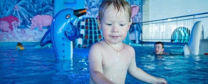 Child Enjoying Water Play At Wisconsin Dells Waterpark With Fun Aquatic Features.