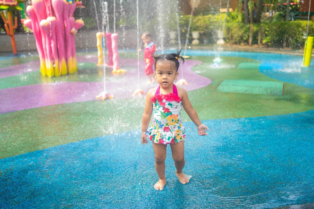  Remove BG Save Share Sample Little preschool asian girl enjoying play in outdoor water park playground