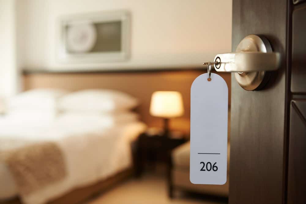 Baby gear rental hotel room setup with room number tag in Waikiki for infant and toddler sleep.