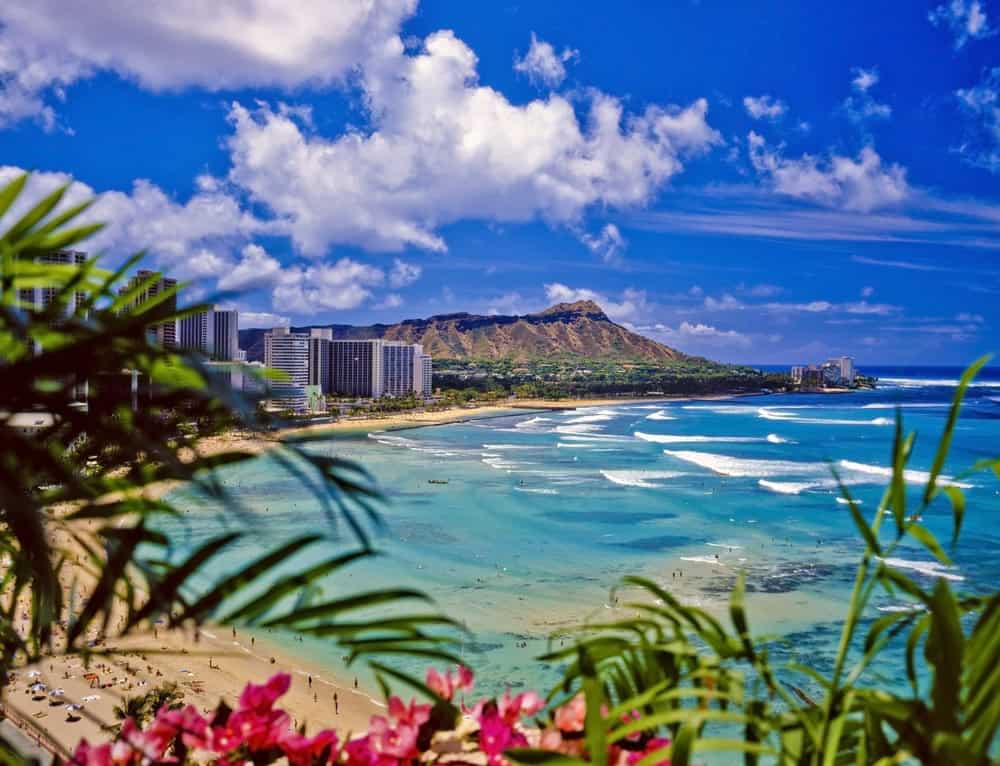 Relaxing Waikiki Beach with calm waters and scenic city views in Hawaii.