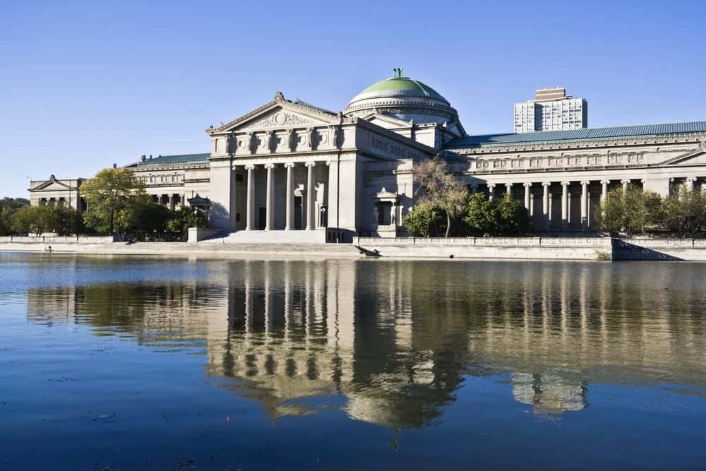 The Ohio Statehouse in Columbus, Ohio, with its classical architecture reflected in the water, under.