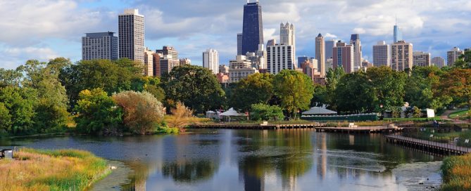 Chicago Skyline With River And Green Park In Foreground, Sunny Day With Clouds.