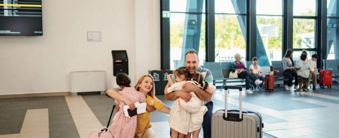 Happy Family With Kids And Grandparents At Airport Terminal With Luggage.