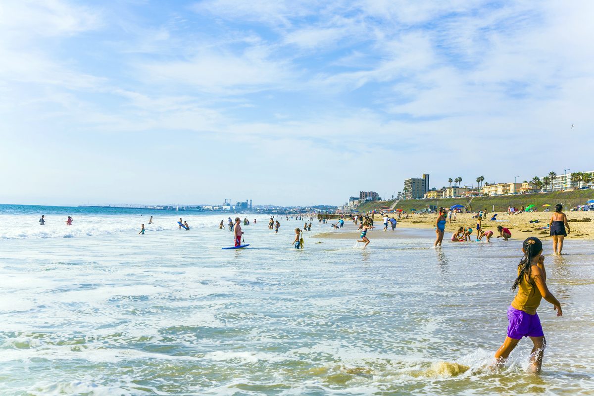 Families Playing In The Shallow Surf On A Sunny Redondo Beach Day Near Seaside Lagoon
