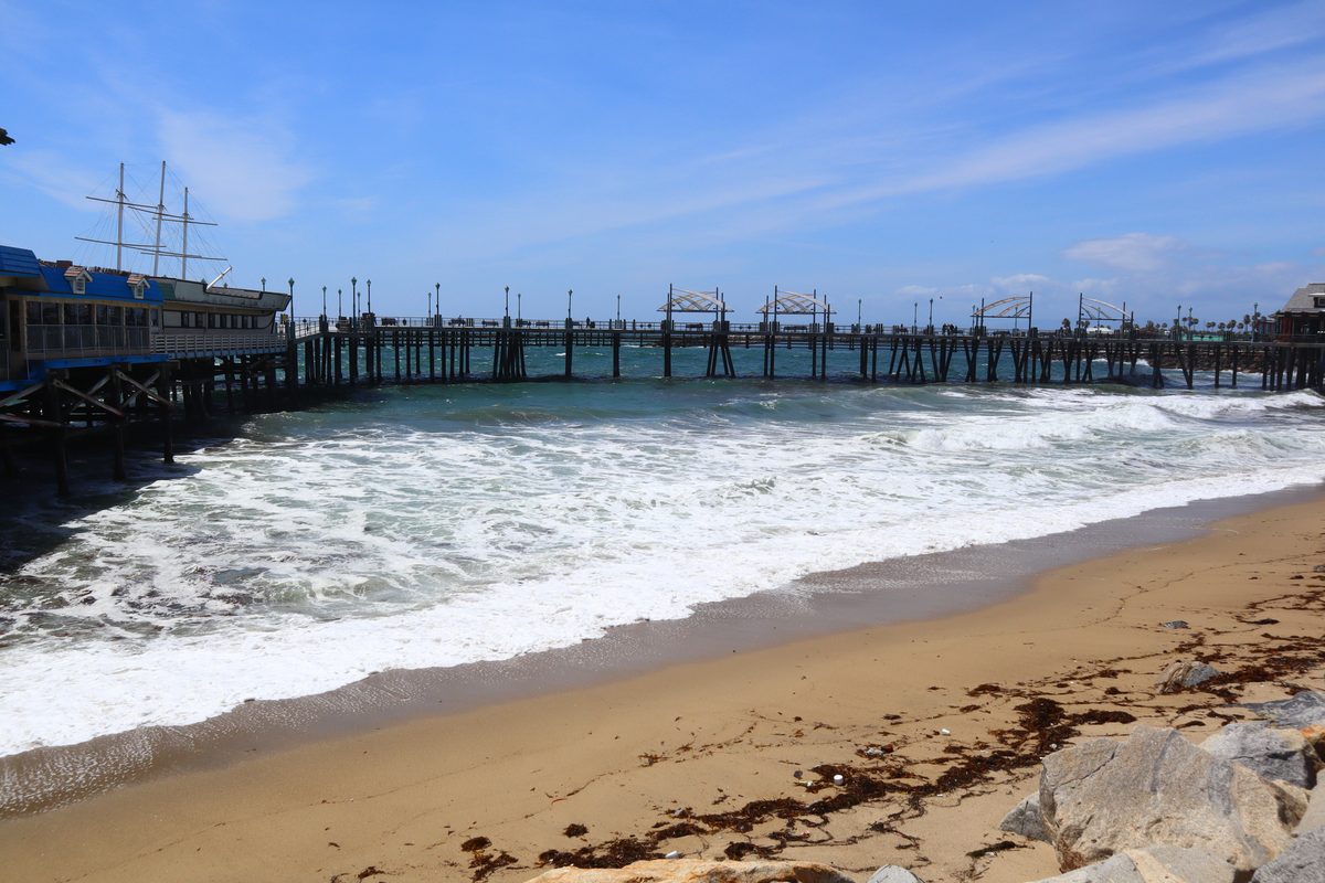 Waves Rolling Onto The Sand Beside The Wooden Pier, A Starting Point For Stroller Walks Near Redondo Beach Pier